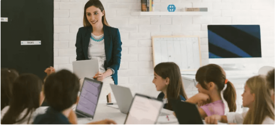 Teacher teaching coding to kids