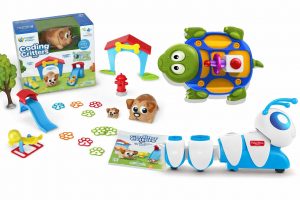 Coding Critters screen-free coding toy set for ages 4+, showing the product box, a blue-and-white robot dog, a green turtle toy, a small puppy figure, paw-print coding tokens, and play accessories like a slide and doghouse on a white background.